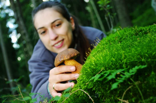 stock image Young woman pick up the mushroom