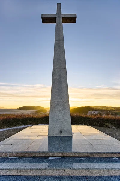 Kamenný kříž památník při západu slunce — Stock fotografie