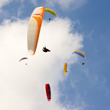 Group of paragliders and blue sky clipart