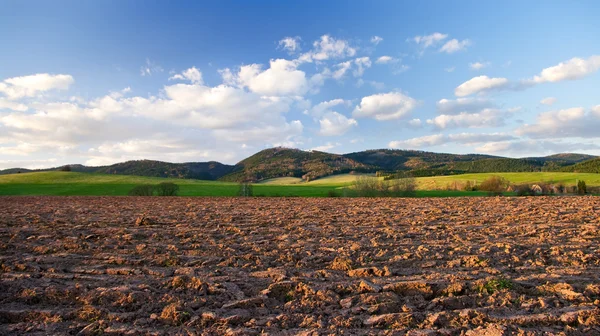 Rural view with plowed field in hills — Stock Photo, Image
