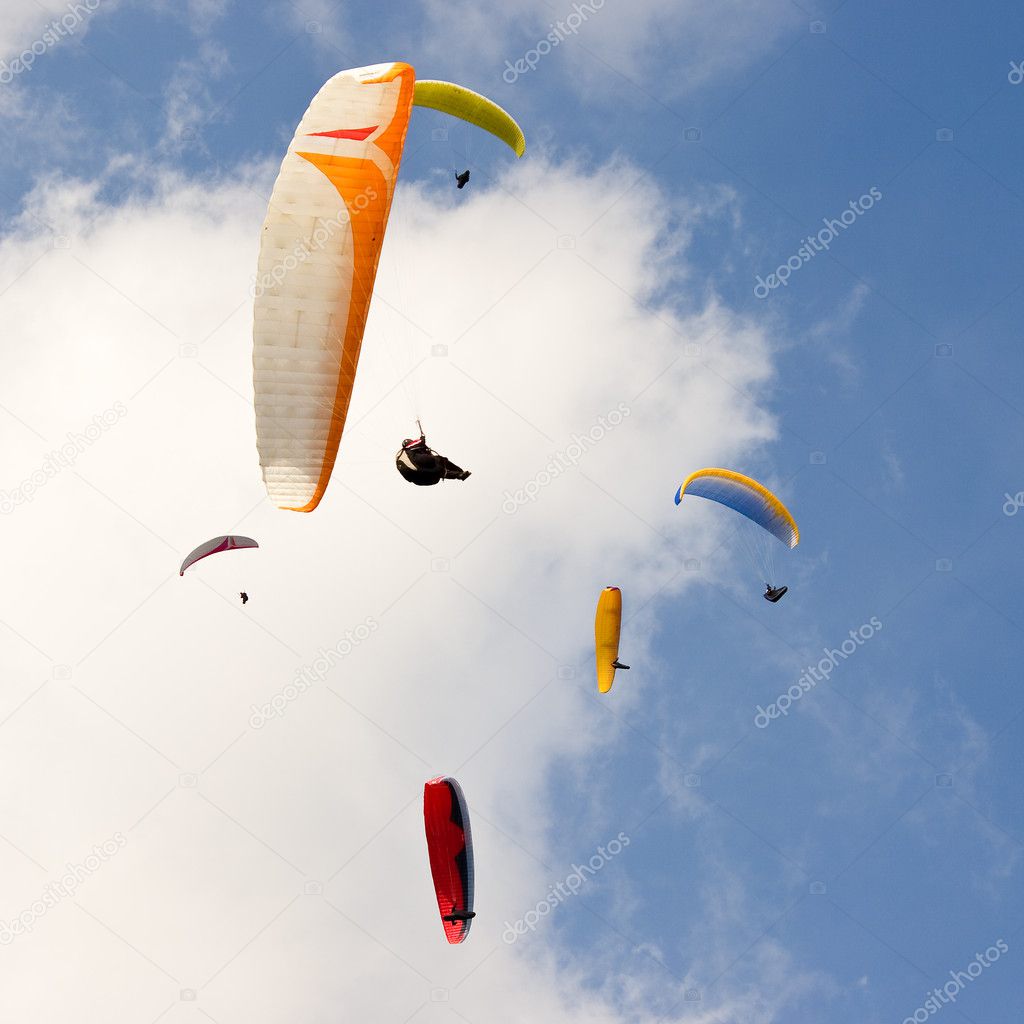 Group of paragliders and blue sky