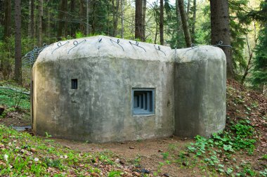 Old concrete bunker in forest clipart