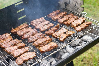 Traditional Croatian cevapcici on the grill clipart