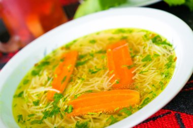 Fresh broth with carrot and parsley clipart