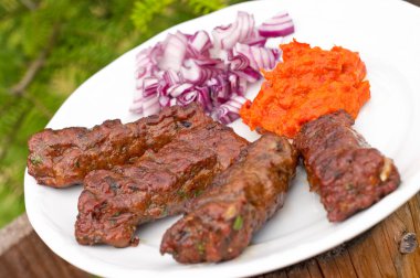 Cevapcici with ajvar paste and red onion clipart