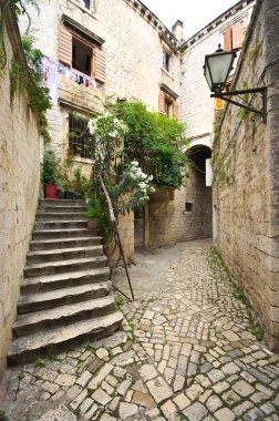 Courtyard with stairs in Mediterranean town clipart