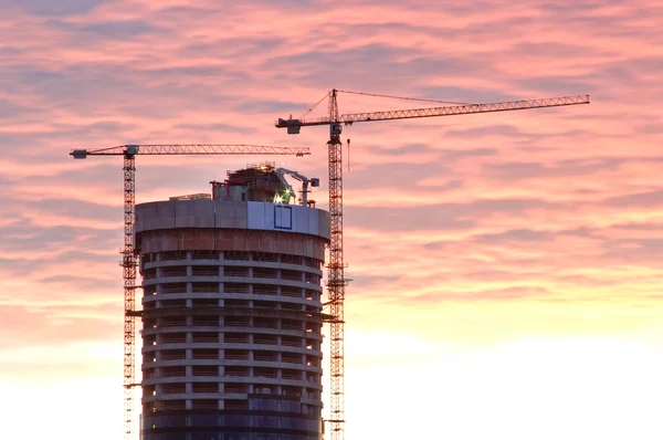 stock image Skyscraper and cranes during the sunset