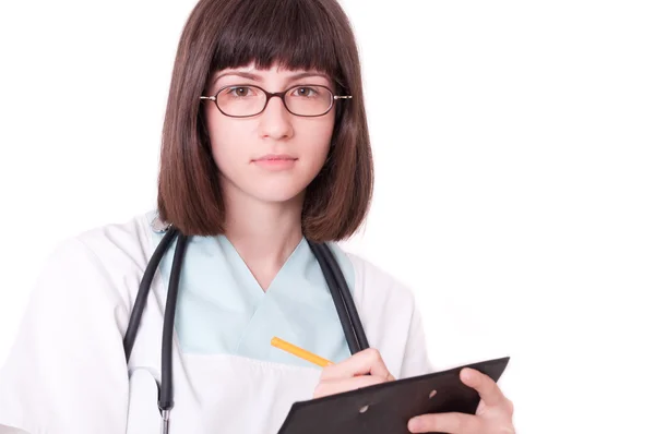 Female doctor holding clipboard and smiling — Stock Photo, Image